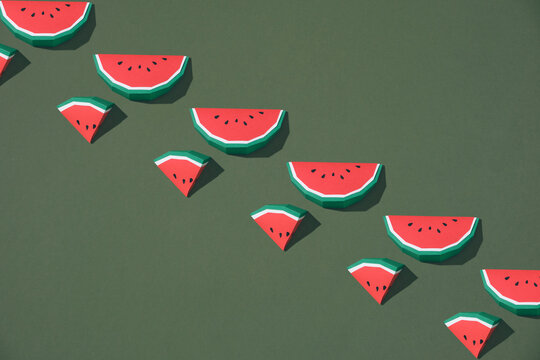 Juicy fruits. Summer wallpaper with slices of watermelon on green background