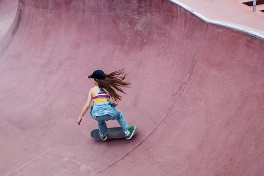 Cool skater girl is skating a bowl 