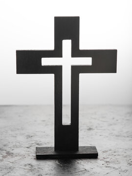 Large black Catholic cross. Faith. Religion. Jesus Christ. God. Minimalism. Close-up. Careful viewing. Black and white tones. There are no people in the photo.