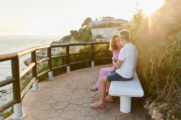 Mature couple sitting on a boardwalk