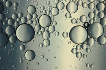 abstract macro background of oil circles floating over water surface .