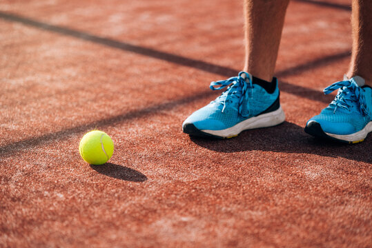 Sportsman legs near padel tennis ball