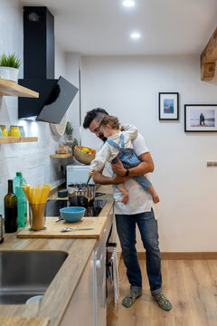 Man and little child cooking in kitchen