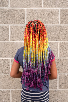 Girl with vibrant rainbow ombre box braids