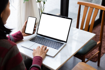 computer screen,cell phone blank mockup.hand woman work using laptop texting mobile.with white background for advertising,contact business search information on desk in cafe.marketing,design