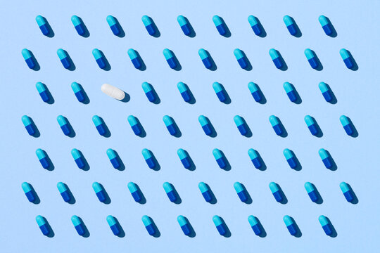 Seamless pattern with blue pills on blue background.