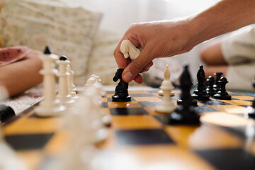 A chess board. Father plays with daughter
