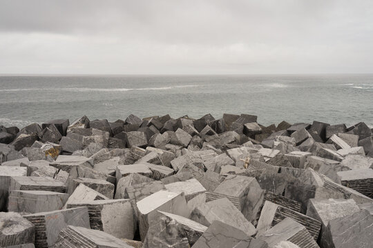 Breakwater wall and sea on a cloudy day