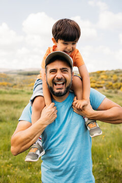 Happy dad with son having fun in countryside