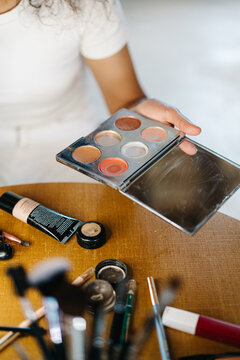 Unrecognizable woman with cosmetic products and accessories