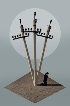 Man in the shadow of electric poles