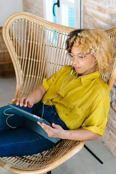 Young woman watching movie on tablet