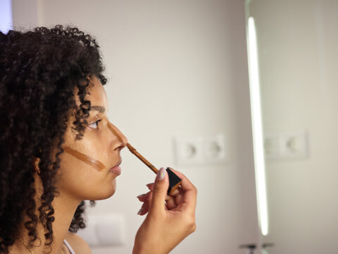 Girl applying makeup.