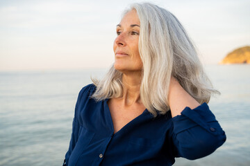Portrait Beautiful mature woman relaxing at beach