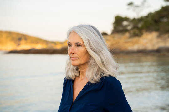 Portrait of Beautiful mature woman relaxing at beach - Powered by Adobe