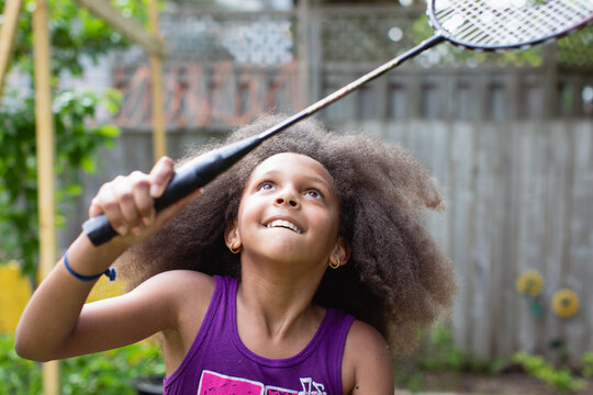 Closeup of a young girl playing badminton with a racket