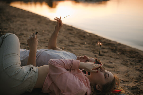 A Guy And A Girl On The Background Of A Lake In Summer