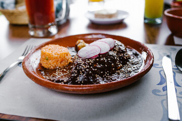 Mole poblano with red rice traditional mexican cuisine in Mexico City restaurant