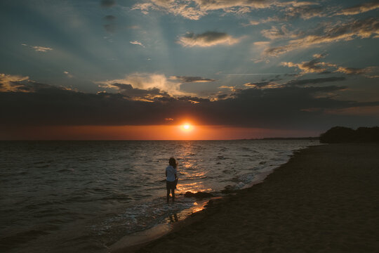 Young girl on beach at sunset