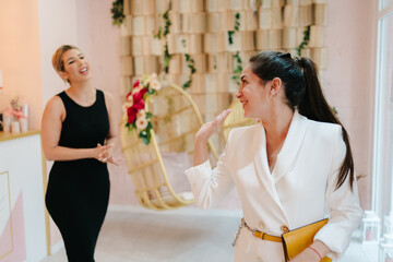Friendly manager giving a farewell to client in beauty salon