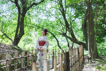 Naklejka na ściany i meble 日本庭園を散策する浴衣の女性