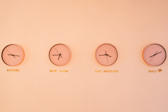 Clocks with different time hanging on wall