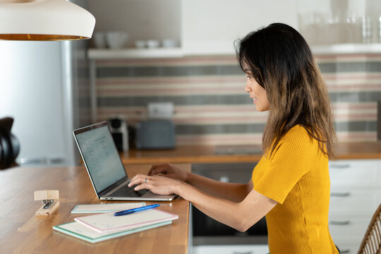 Asian freelancer using laptop at home