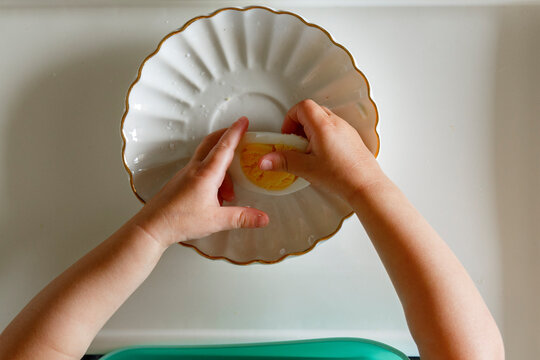 Little kid eating egg for breakfast