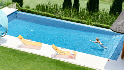 Woman swimming in a pool in summer