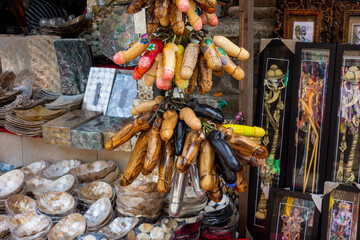 Traditional Balinese souvenirs and wooden decorated Phallus in a street market of Ubud