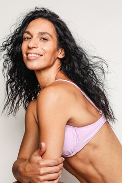 Sexy latino model wearing a purple swimsuit
