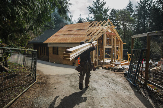 Man working on the roof doing construction in winter