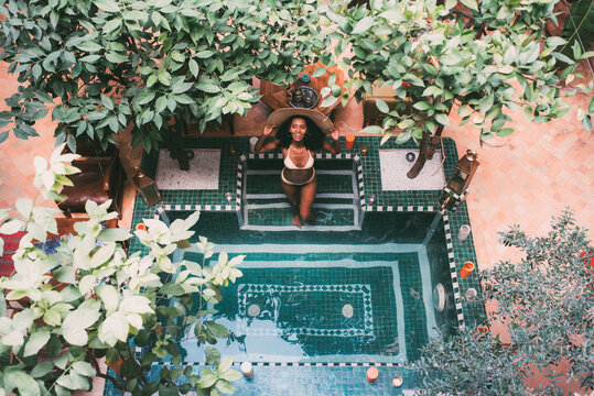 Woman leaning in a mosaic floor in a swimming pool