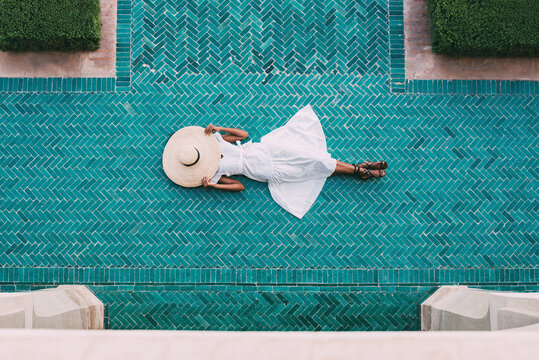Woman lying down in a geometric mosaic floor