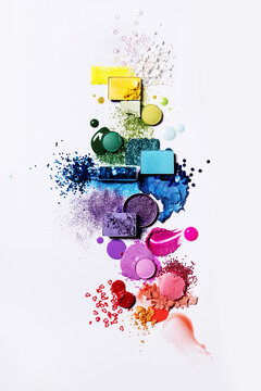 Colourful cosmetics flat lay rainbow with powder, liquid and glitter