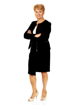 Full Body Shot Of An Elegant Old Polish Woman Wearing A Black Suit, Posing Against White Background