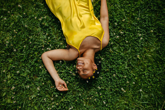  Black Woman Laying Down In The Grass.