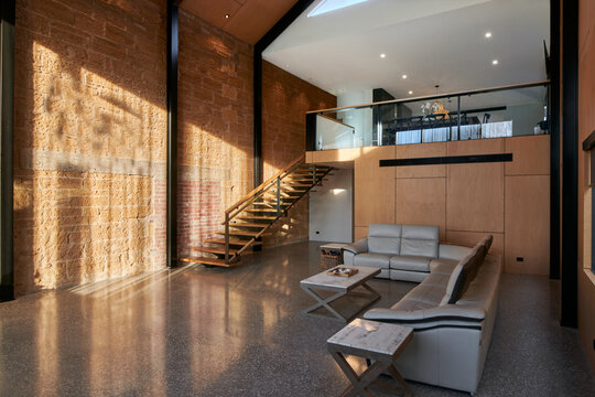 Luxury sunlit house interior with high ceiling