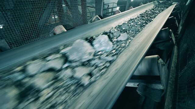 Metal transporter is moving fast with crushed minerals on it