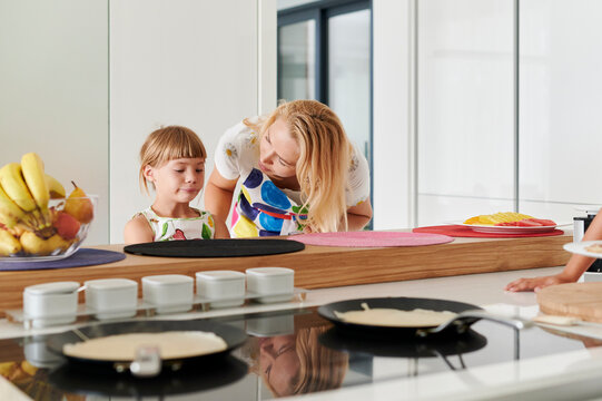 Mom talking with her daughter at breakfast