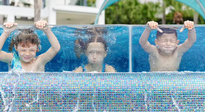 Children holding their breath underwater in a pool