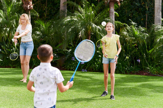 Family playing badminton in their yard