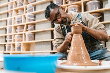Latino male artisan at the lathe