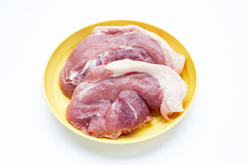 Pork meat in yellow plate on white background.