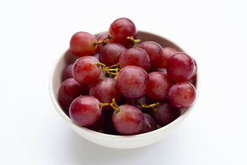 Fresh grape in white bowl background.