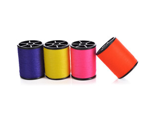 Colourful thread spools isolated on a white background.