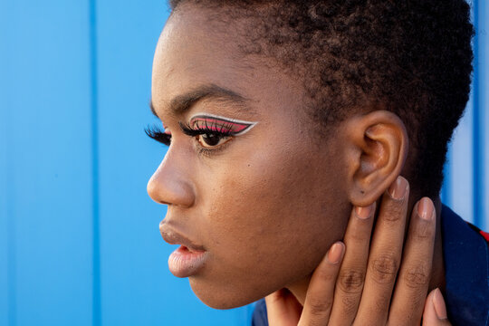 Black woman with creative makeup looking away