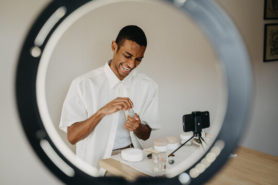 Young Man Doing Beauty Routine Video Tutorial At Home