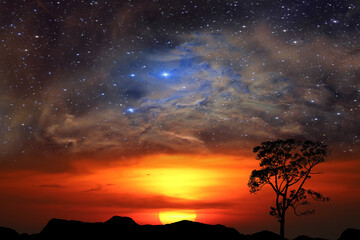 Fototapeta na wymiar half sun back red cloud over mountain and nebula galaxy on the sunset sky
