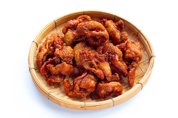 Chispy fried chicken skin in bamboo basket on white background.